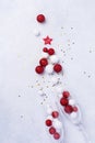 Two glasses for champagne and Christmas champagne bottle with sprinkles in the form of Christmas tree made of red and white toys Royalty Free Stock Photo