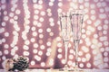 Two glasses of champagne with Christmas toys. Festive lights bokeh background