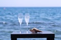 Two glasses of champagne in fronf of blue sea