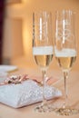 Two glasses of a champagne and pillow with wedding rings Royalty Free Stock Photo