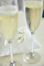 Two glasses of a champagne and pillow with wedding rings. Royalty Free Stock Photo