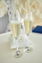 Two glasses of a champagne and pillow with wedding rings Royalty Free Stock Photo