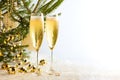 Two glasses of champagne ready to bring New Year on Christmas tree background Royalty Free Stock Photo