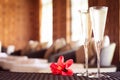 Two glasses of champagne with red flower in a spa lounge. Spa ti Royalty Free Stock Photo