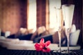 Two glasses of champagne with red flower in a spa lounge. Spa ti Royalty Free Stock Photo