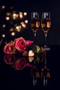 Two glasses of champagne, roses and heart shape chocolates