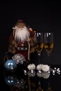 Two glasses champagne, Santa Claus and Christmas decoration Royalty Free Stock Photo