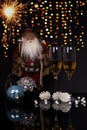 Two glasses champagne, Santa Claus and Christmas decoration Royalty Free Stock Photo