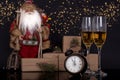 Two glasses with champagne, Santa Claus and christmas gifts Royalty Free Stock Photo