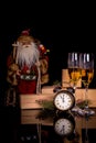 Two glasses with champagne, Santa Claus and christmas gifts Royalty Free Stock Photo