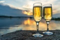 Two glasses with champagne on the background of the sunset, in nature, outdoors. Royalty Free Stock Photo