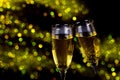 Two glasses of champagne with sparkling lights