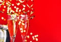 Two glasses champagne streamer lights red background Royalty Free Stock Photo