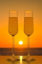 Two glasses of champagne on sunset sea background Royalty Free Stock Photo