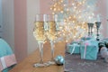 Two glasses of champagne surrounded by Christmas New year background and decoration, light bokeh effect Royalty Free Stock Photo