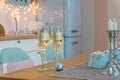 Two glasses of champagne surrounded by Christmas New year background and decoration, light bokeh effect and light garland Royalty Free Stock Photo