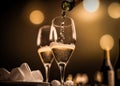 Two glasses of champagne, toasting at night with bokeh lights Royalty Free Stock Photo