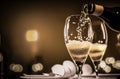 Two glasses of champagne, toasting at night with bokeh lights Royalty Free Stock Photo