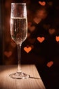 Two glasses of champagne, which stand on a black background with a beautiful bokeh, glasses against the background