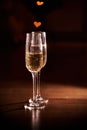 Two glasses of champagne, which stand on a black background with a beautiful bokeh, glasses against the background