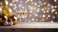 Two glasses of champagne on the wooden table with party ornament and balloons in white and gold colors, with beautiful light bokeh Royalty Free Stock Photo