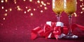 Two glasses of champagne with wrapped gift purple glitter background