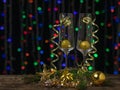Two glasses with Christmas balloons and ribbons on a background of colored bokeh. Royalty Free Stock Photo