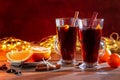 Two glasses of christmas mulled wine with oranges and spices on wooden table Royalty Free Stock Photo