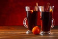 Two glasses of christmas mulled wine with oranges and spices on wooden table Royalty Free Stock Photo