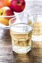 Two glasses of cider on the wooden background Royalty Free Stock Photo