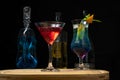 Two glasses with cocktails, red drink and blue drink photographed on a wooden board Royalty Free Stock Photo