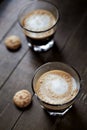 Two Glasses Of Coffee with Milk on dark wooden background. Royalty Free Stock Photo