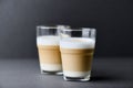 Two Glasses Of Coffee with milk on gray background. Close up. Royalty Free Stock Photo