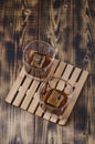 Two Glasses of cognac with ice cubes on a wooden table/Two Glasses of cognac with ice cubes on a wooden table. Top view Royalty Free Stock Photo