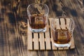 Two Glasses of cognac with ice cubes on a wooden table/Two Glasses of cognac with ice cubes on a wooden table. Top view Royalty Free Stock Photo