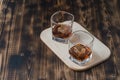 Two Glasses of cognac with ice cubes on a wooden table./ Two Glasses of cognac with ice cubes on a wooden background Royalty Free Stock Photo