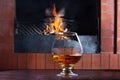 Two glasses of cognac on old brick fireplace Royalty Free Stock Photo