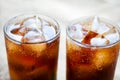 Two glasses of cola with ice. Close-up of a refreshing drink
