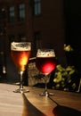 Two glasses with cold beer and cider on wooden cafe table. Dark blur background with copy space Royalty Free Stock Photo