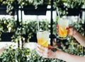 Two glasses of cold fresh lemonade in hands Royalty Free Stock Photo