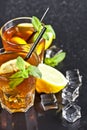 Two glasses with cold traditional iced tea with lemon, mint leaves and ice cubes Royalty Free Stock Photo