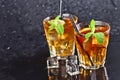 Two glasses with cold traditional iced tea with lemon, mint leaves and ice cubes Royalty Free Stock Photo