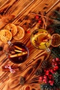 Two glasses cups of red and white mulled wine or gluhwein with spices and orange slices on rustic wooden table top view Royalty Free Stock Photo