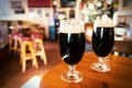 Two glasses of dark beer in a bar Royalty Free Stock Photo