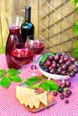 Two glasses of delicious homemade semisweet red wine with grape