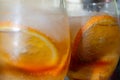 Two glasses. Two drinks with orange ice tea. Oranges slices. Close up 2