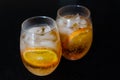 Two glasses. Two drinks with orange ice tea. Oranges slices 2