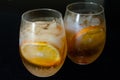 Two glasses. Two drinks with orange ice tea. Oranges slices 3
