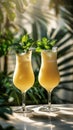 Two glasses filled with cocktails sit on top of a wooden table, ready to be enjoyed Royalty Free Stock Photo