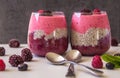 Two glasses filled with layered Blueberry Raspberry smoothie
